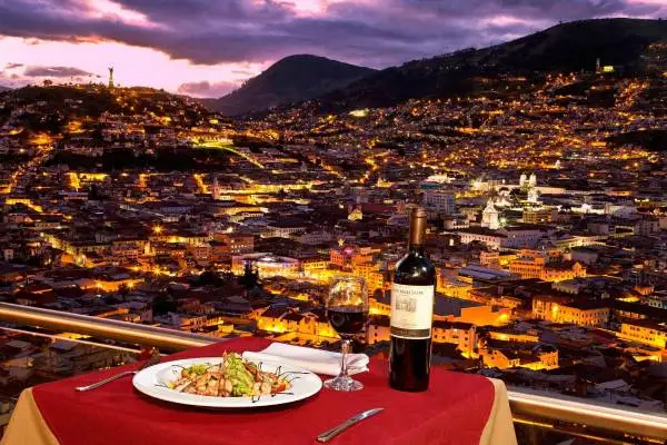 Rooftop bar in Quito Ecuador with views of colonial churches and the Historic Center at night