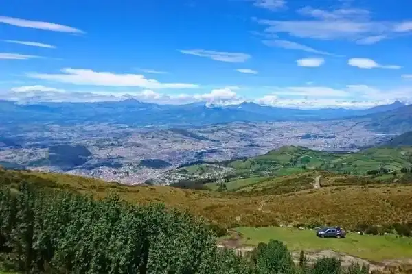 Aerial view of Quito city spread across the Andean valley from a mountain overlook