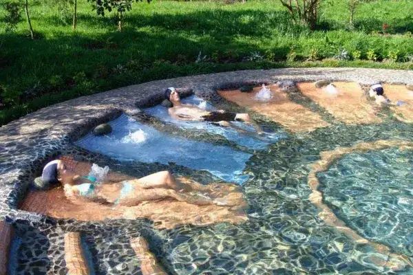 Visitors relaxing in the terraced thermal pools of Termas de Papallacta