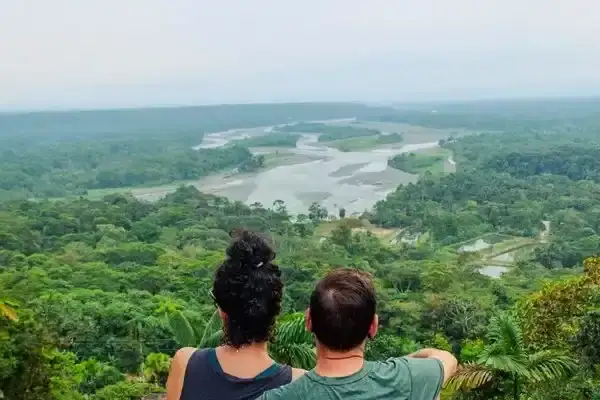 Couple looking out over the Amazon rainforest canopy from a viewpoint