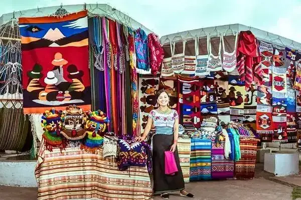 Otavalo market ecuador Kichwa weaver with handmade alpaca ponchos