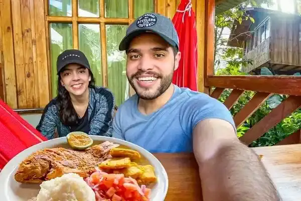 Couple enjoying a traditional Ecuadorian lunch plate on a Mindo restaurant terrace