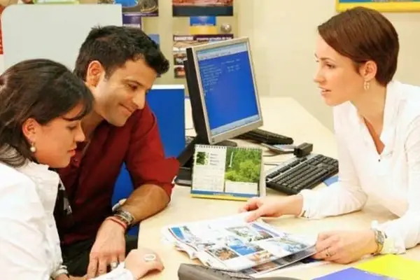 Couple planning a Galapagos on a budget trip with a travel agent