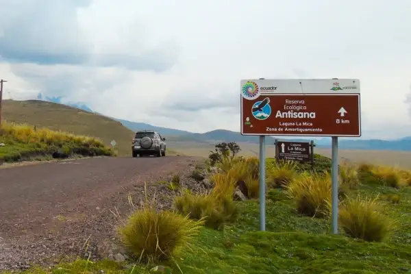 Road sign for Antisana Ecological Reserve and Laguna La Mica on the gravel access road