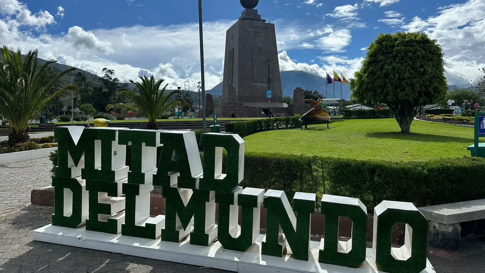 Green Mitad del Mundo letters in front of the equator monument north of Quito